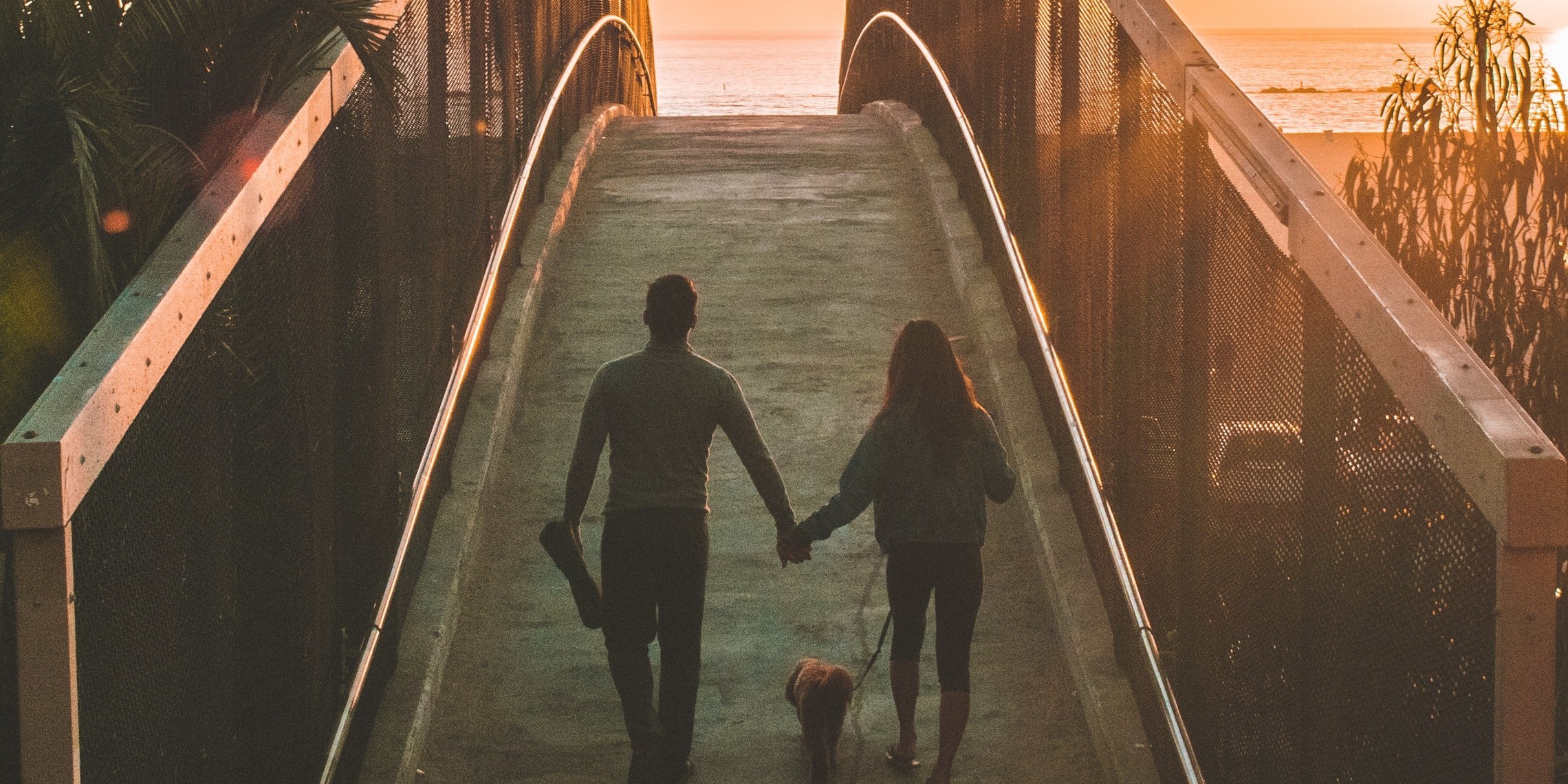 Couple crossing bridge